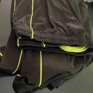 Left side piping in green, shiny, silky, puma, suede pants size medium